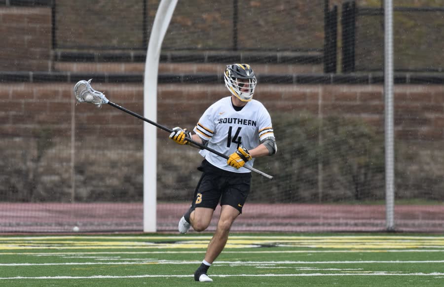 Cade running upfield in the rain